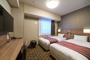 Postel nebo postele na pokoji v ubytování Hotel WBF Namba Motomachi