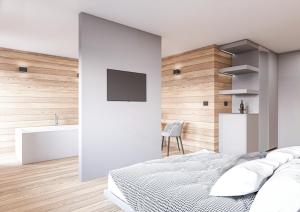 Hotel Relais Des Glaciers - Adults Only في تشامبولوك: غرفة نوم بجدران بيضاء وسرير ومغسلة