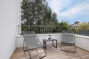 two chairs and a table on a balcony at Appartement moderne pour 4 a La Baule in La Baule