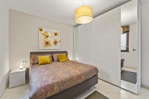 a bedroom with a large bed with yellow pillows at Ca' Alessandra in Carloforte