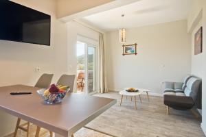 a living room with a table and a couch at Karpathos City View Apartments in Karpathos