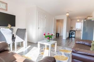 a living room with a couch and a table at Entire House with 3 Rooms in Liverpool