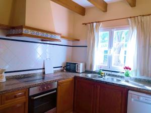 a kitchen with a sink and a microwave at Villa Paula in Son Carrio