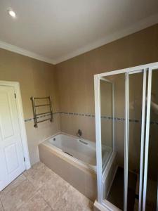 a bathroom with a bath tub in a room at Elgin Townhouse-Excellent location in Cape Town
