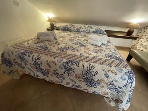 una camera con un letto con una coperta blu e bianca di MARE AZZURRO a Campofelice di Roccella