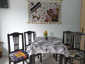 a dining room table with chairs and a tablecloth on it at 10 apartmants Olimpia MIR in Durrës