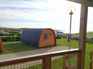 a hobbit house on a deck with a fire hydrant at Bungalow 3 personas - Camping Playa de Tapia in Tapia de Casariego