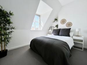 a white bedroom with a bed and a window at NEW Oxford Circus 2 Bedr, 3 Beds Best Location in London