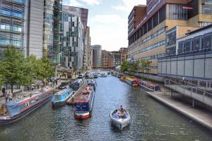 a group of boats in a river in a city at Luxury Apartment located near Marble Arch & Baker Street in London