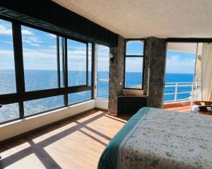 a bedroom with a view of the ocean at Sea lover's nest in Los Realejos