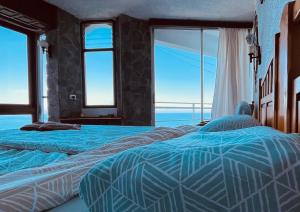two beds in a room with a view of the ocean at Sea lover's nest in Los Realejos