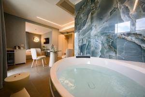 a bathroom with a large tub in a room at Villa Nicolli Romantic Spa Resort - Adults Only in Riva del Garda