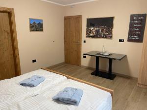 a bedroom with a bed and a table with towels on it at Josanica Bed&Breakfast in Konjic