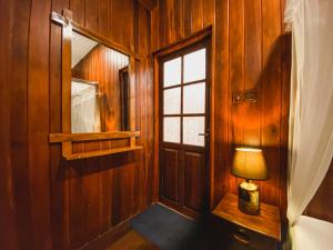 a lamp sitting next to a door in a room at Levon Boutique Hotel in Ella