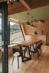 a dining room with a wooden table and chairs at Haita Land in Vatra Dornei