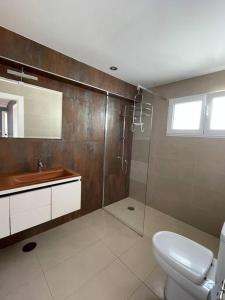 a bathroom with a toilet and a sink and a shower at MyHouseSpain - Ático con terraza en la playa in Gijón