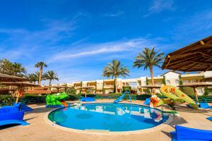 a swimming pool at a resort with a slide at Golden Beach Resort in Hurghada