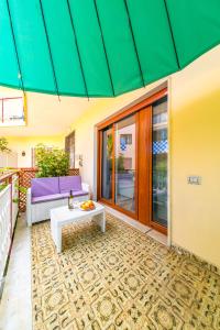 a patio with a couch and a table at Il Riccio di Mare a 5 minuti da Sorrento in Sant'Agnello