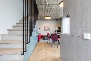 a staircase in a room with a table and chairs at Sakalo kopa in Palanga