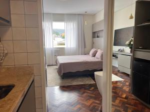 a small bedroom with a bed and a bathroom at Apartamento Luxo Copacabana com vista Cristo Redentor in Rio de Janeiro