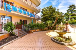 a building with a fountain in front of it at Il Riccio di Sole a meno di 5 minuti da Sorrento in Sant'Agnello