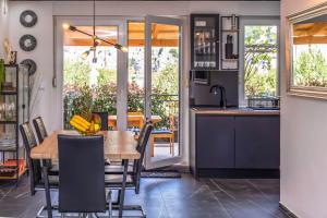 a kitchen and dining room with a table and chairs at Downtown Deluxe in Omiš