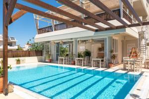 a swimming pool in a villa with a house at GOJI Vegan Hotel in Ialyssos