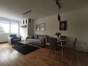 a living room with a couch and a table at Downtown apartment in Subotica