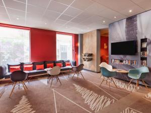 a conference room with chairs and a flat screen tv at ibis Jerusalem city Center - An AccorHotels Brand in Jerusalem