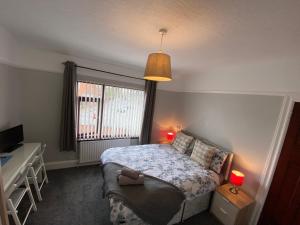 a small bedroom with a bed and a window at Crumlin Road Town House in Belfast