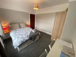 a bedroom with a bed and a table and chairs at Crumlin Road Town House in Belfast