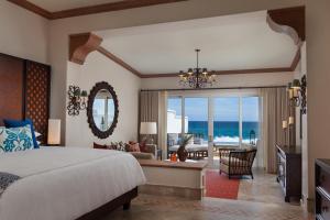a bedroom with a bed and a view of the ocean at One&Only Palmilla in San José del Cabo
