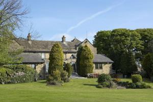 a large house with a lawn in front of it at The Old Golf House Sure Hotel Collection by Best Western in Huddersfield