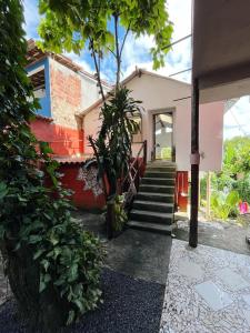 a house with stairs leading to the front door at Morada Cacauêra in Itacaré