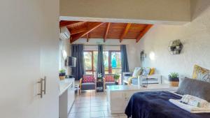 a room with a bed and a living room at San Lameer Villa 2516 by Top Destinations Rentals in Southbroom
