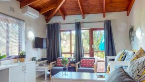 a living room with a couch and a table at San Lameer Villa 2516 by Top Destinations Rentals in Southbroom