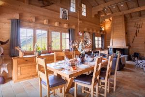 a dining room with a wooden table and chairs at Chalet Flocon Magique - OVO Network in Saint-Jean-de-Sixt