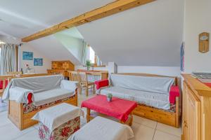 a living room with two beds and a table at Apartments ApArt Bled in Bled +88 photos