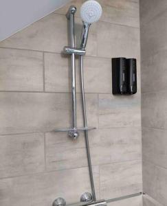 a shower with a microphone on top of a wall at La Bohème in Challuy