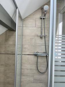 a shower with a glass door in a bathroom at La Bohème in Challuy +22 photos