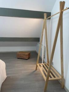 a room with a bed and a wooden ladder at La Bohème in Challuy