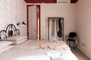 a bedroom with a white bed and a closet at 206 Via Roma in Linguaglossa
