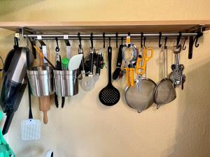 a bunch of kitchen utensils hanging on a wall at Top ausgestattete Ferienwohnung in Stinteck nahe Büsum in Westerdeichstrich +3 photos