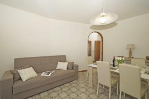 a living room with a couch and a table at Casa Pelèr - Gardagate in Toscolano Maderno