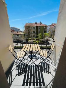a patio with a table and chairs on a balcony at Private Rooms Trakiets in Pomorie
