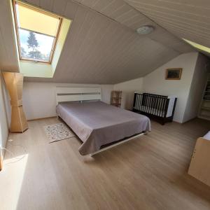 a bedroom with a bed in a attic with a window at Amber Coast & Sea in Jūrmala