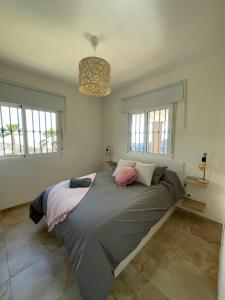 a large bed in a room with windows at Casa Helen in Torrox