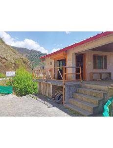 a house with a staircase in front of it at Hotel Mountain View, Chakrata in Chakrāta