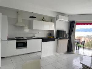 a kitchen with white appliances and a table with a view at Appartement vacances cannes in Cannes