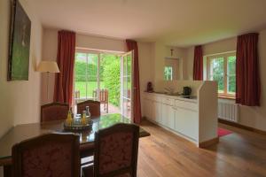 a kitchen and dining room with a table and a kitchen with a tablektop at Schloss Wissen in Weeze